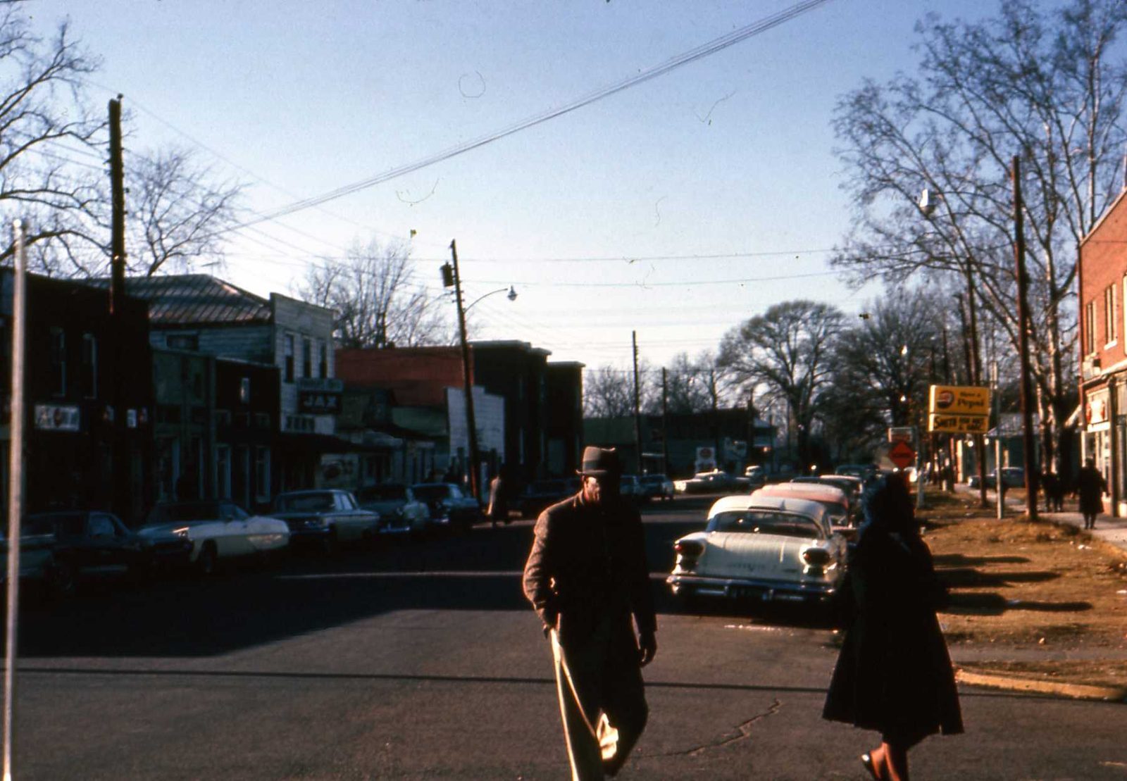 Pedestrians and cars on a downtown Greenville street in 1966